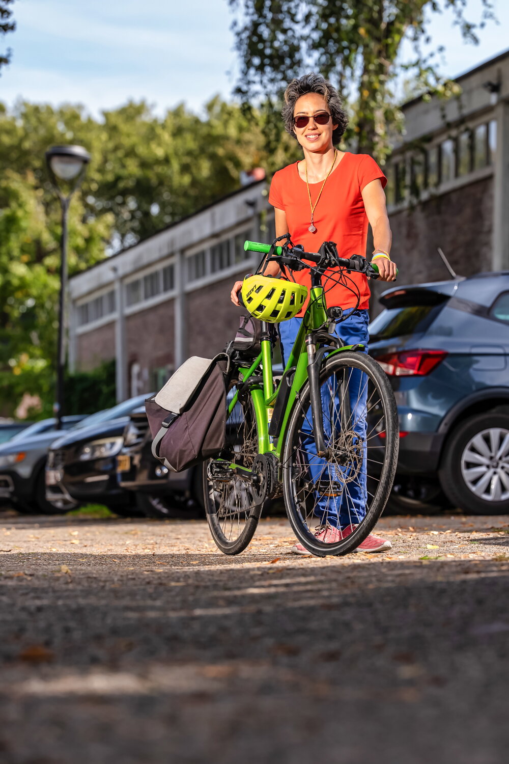 Donna bij haar fiets en lacht naar camera